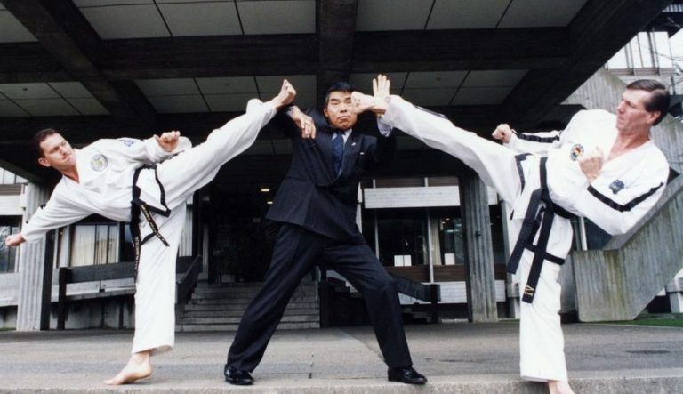 Surrey Taekwon-Do image of Taekwon-Do in Europe founder Grand Master Rhee Ki Ha blocking kicks by two Taekwon-Do students