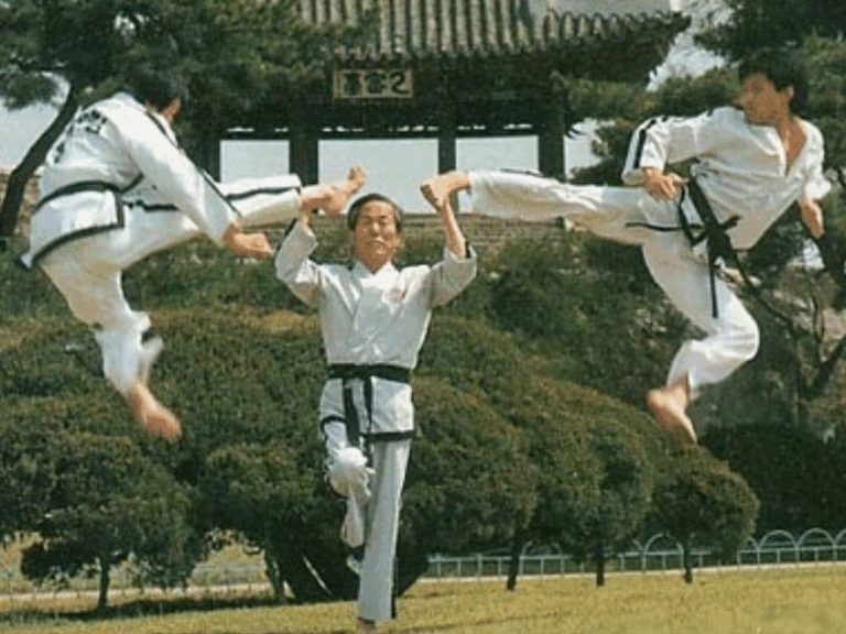 Taekwon-Do founder General Choi Hong Hi blocking kicks by two Taekwon-Do students